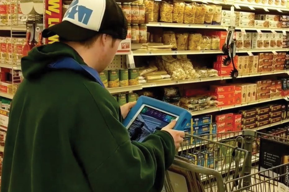 man in store looking at tablet